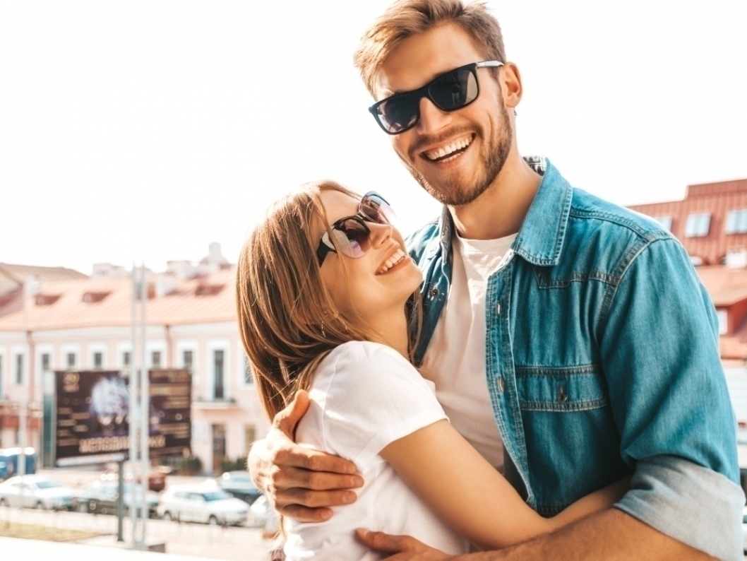 Portrait of smiling beautiful girl and her handsome boyfriend. Woman in casual summer jeans clothes.