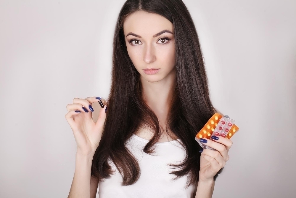 woman taking medicine beautiful girl with pill pack with pills